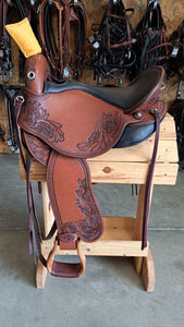 dp saddlery quantum short and light western with a western dressage seat, side view on a wooden saddle rack, horse tack in the background