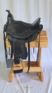 dp saddlery quantum western with a western dressage seat, side view on wooden saddle rack, white background