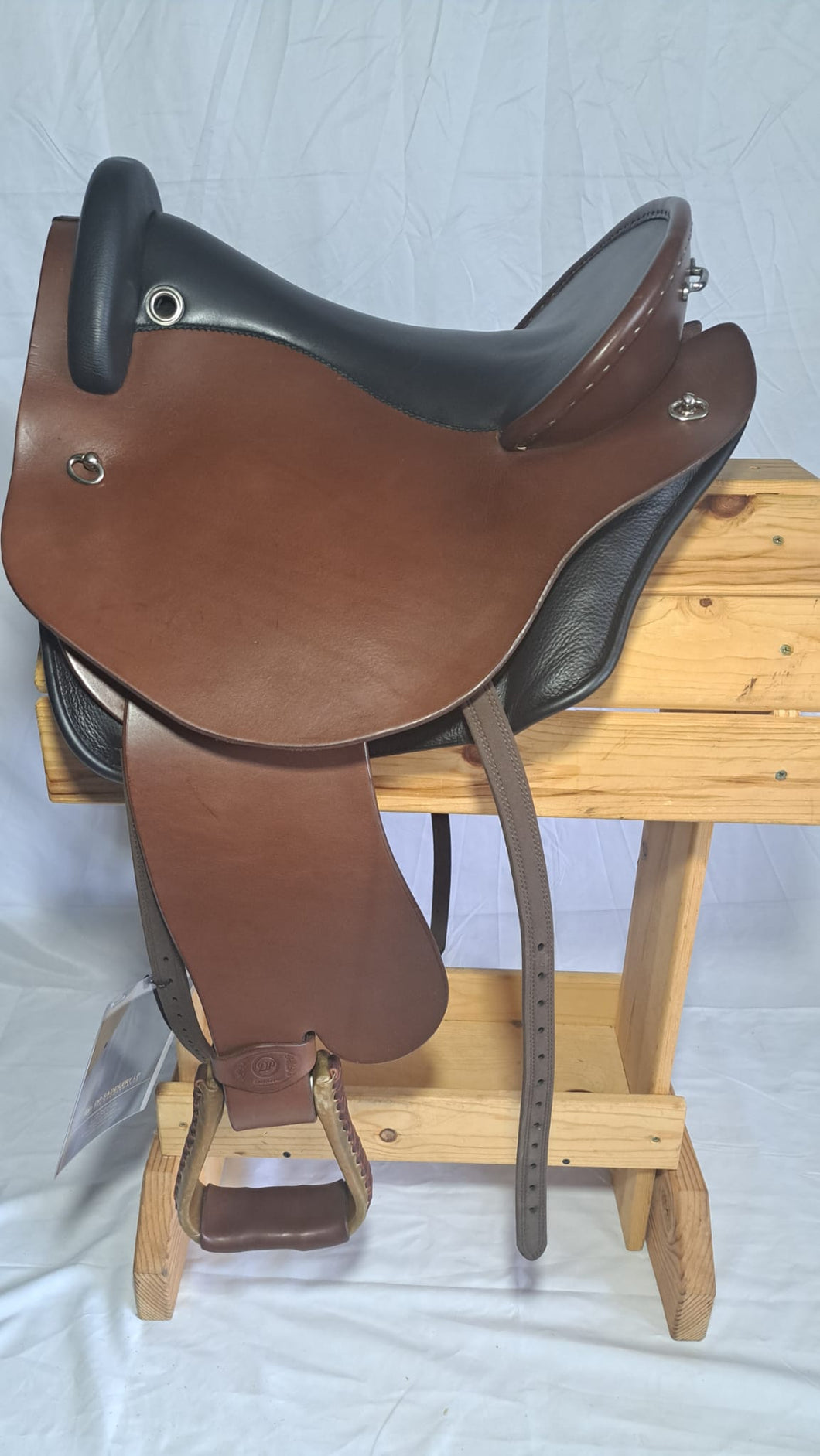 dp saddlery quantum with fenders SKU 7157- side view on a wooden saddle rack - white background