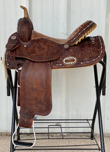 Load image into Gallery viewer, alamo saddlery vintage glam barrel saddle, side view on a metal saddle rack