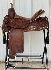 alamo saddlery vintage glam barrel saddle, side view on a metal saddle rack