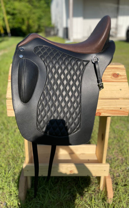 Side view of saddle on wooden saddle rack