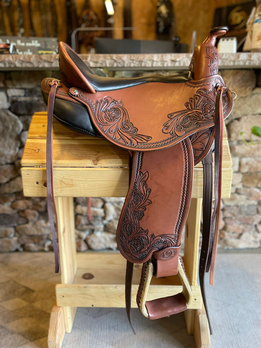 dp saddlery quantum short and light with a western dressage seat 5149, side view on wooden saddle rack 