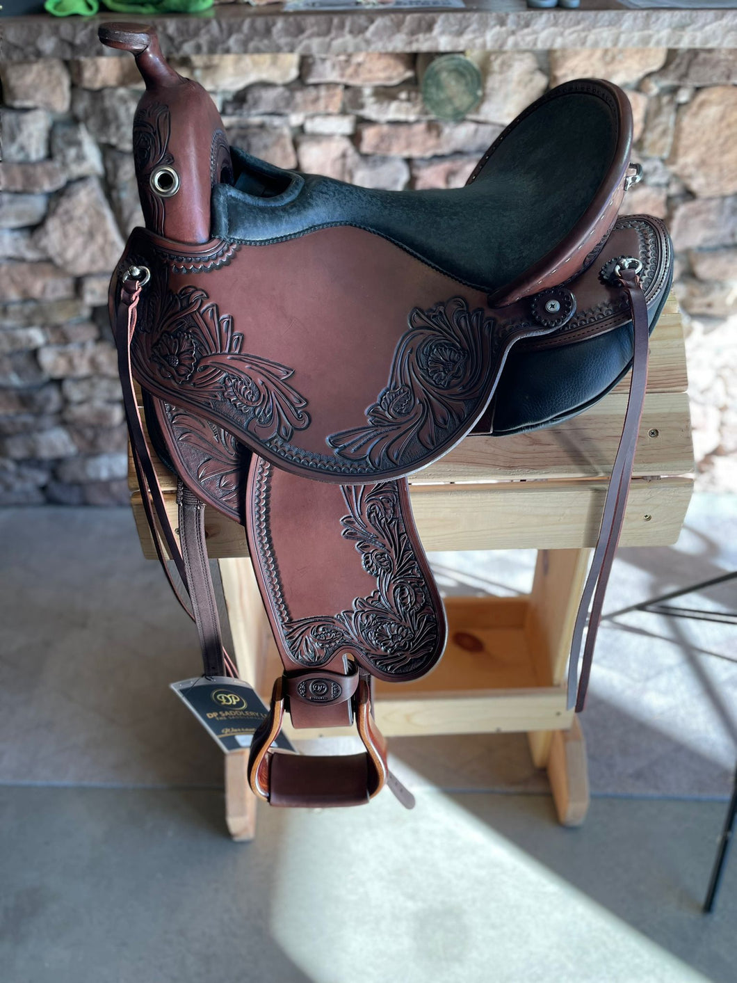 dp saddlery quantum short and light western with a western dressage seat 5316, side view on wooden saddle rack