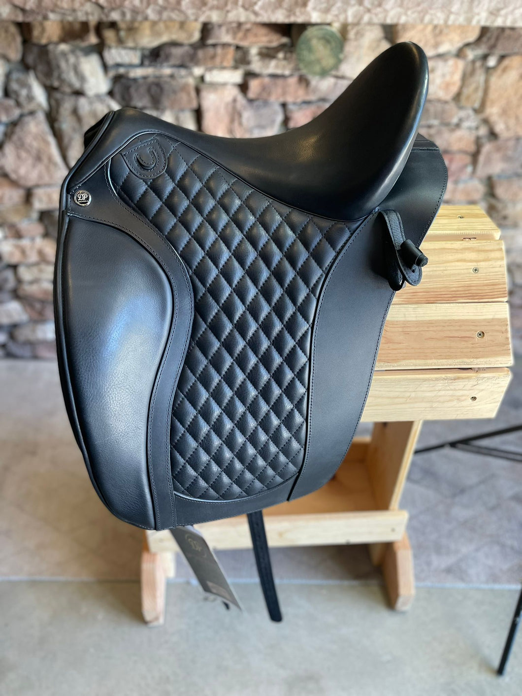 Side view of saddle on wooden saddle rack