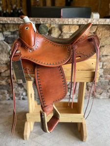 Side view of saddle on wooden saddle rack