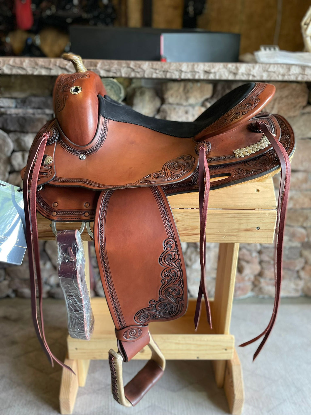 Side view of saddle on wooden saddle rack