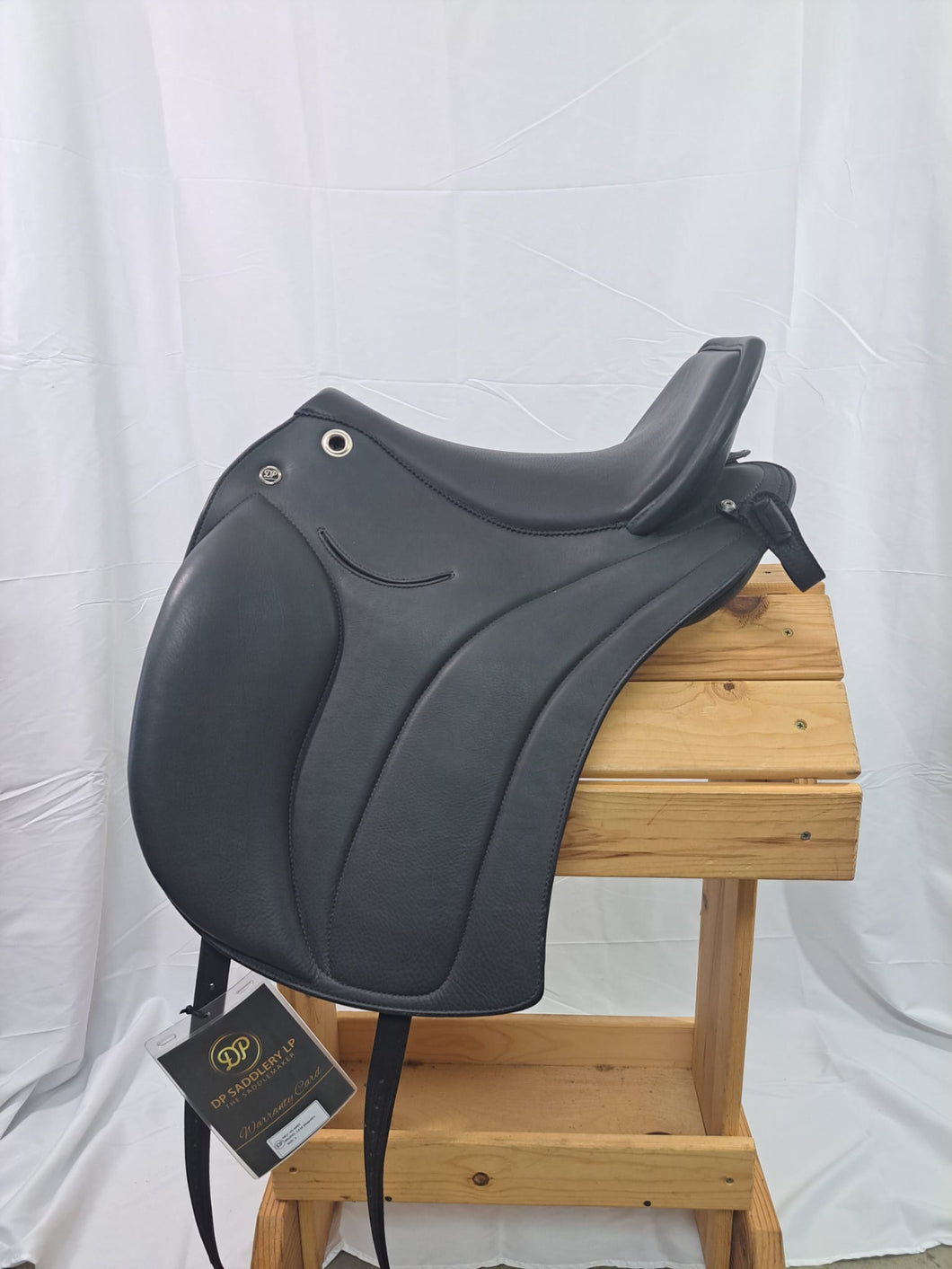 Side view of saddle on wooden saddle rack