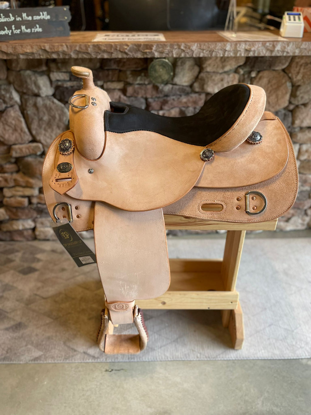 Side of saddle on wooden saddle rack